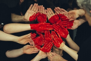 Collection of hands with a heart in the middle.
