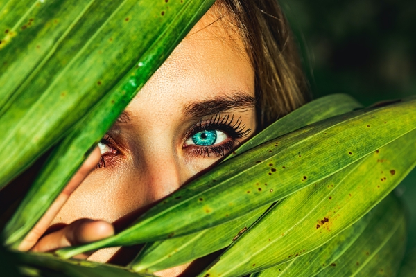 Girl holding out plant in soil